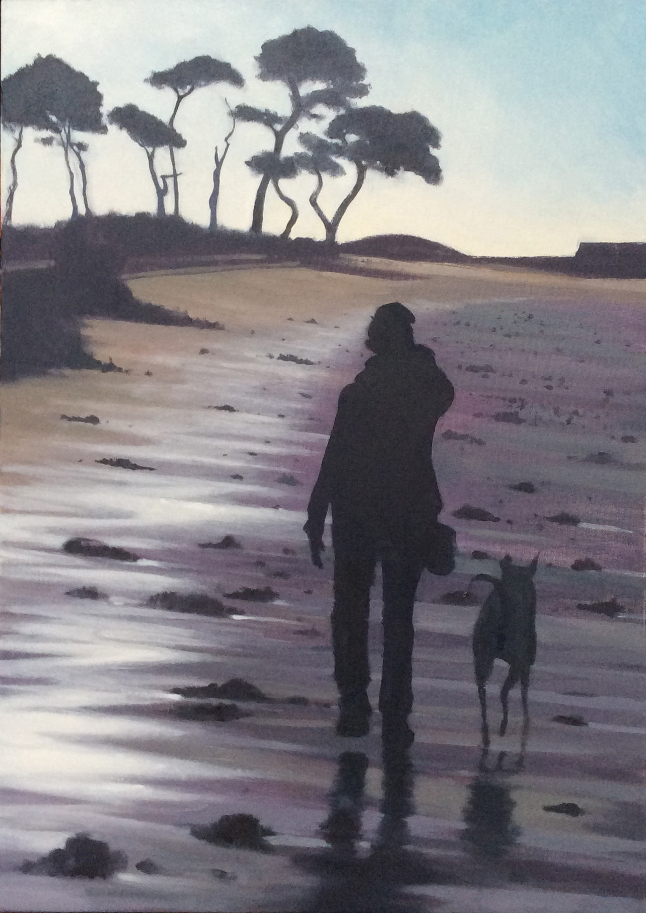 Figure walking on Brittany Beach with dog